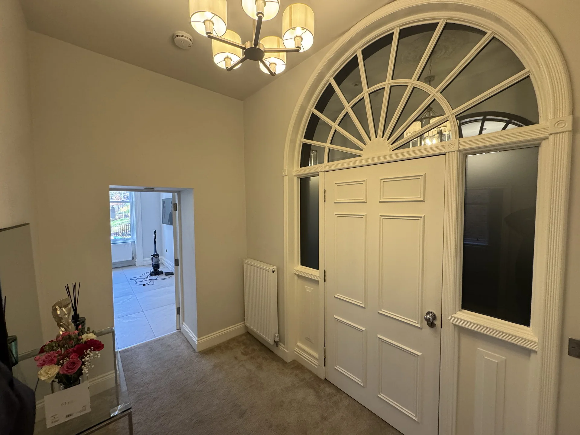 Georgian entrance hall with arched fanlight door and chandelier