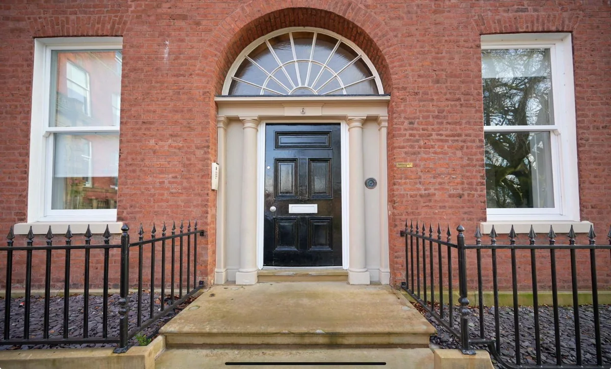 Georgian front of 6 Winckley Square, Preston, Lancashire, with black door and iron railings